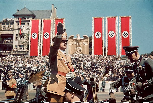 Adolf Hitler salutes troops of the Condor Legion, who fought alongside Spanish Nationalists in the Spanish Civil War, during a rally upon their return to Germany, 1939.