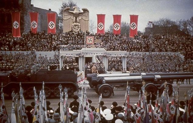 22. Heavy artillery passes the reviewing stand during a military parade in celebration of the birthday, Berlin, 1939.