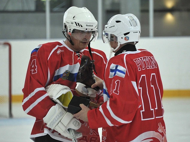 Putin is with Finnish President Sauli Niinisto during a friendly ice hockey game at an ice palace.