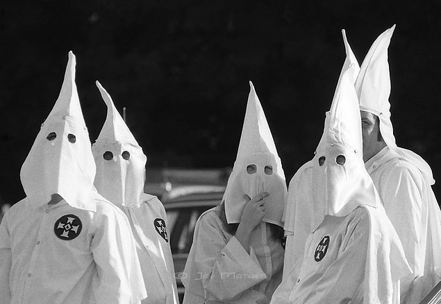 8. Klan members–often wearing masks and dressed in the organization’s signature long white robes and hoods