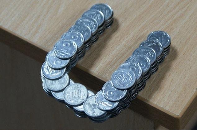 26. These coins that stand in the side of this table without falling down