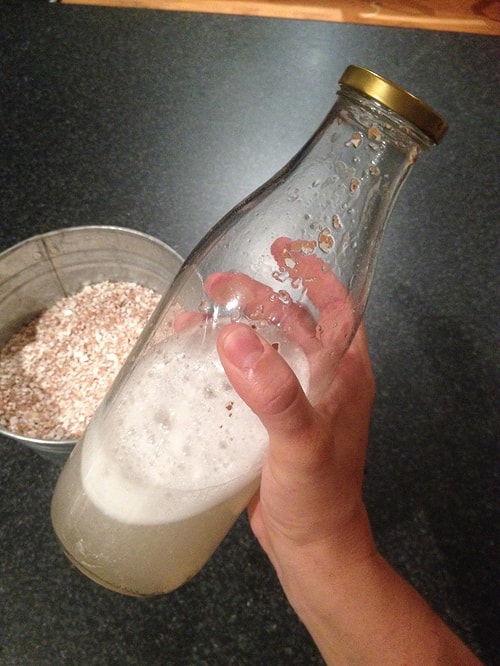 The best way to clean up a bottle with a narrow top is to use eggshells and water! Just shake it thoroughly and you'll see the difference!