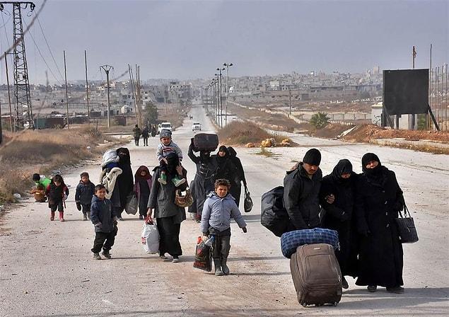 1. Syrian families, fleeing eastern Aleppo, carry their belongings towards government-controlled western Aleppo on Nov. 29.