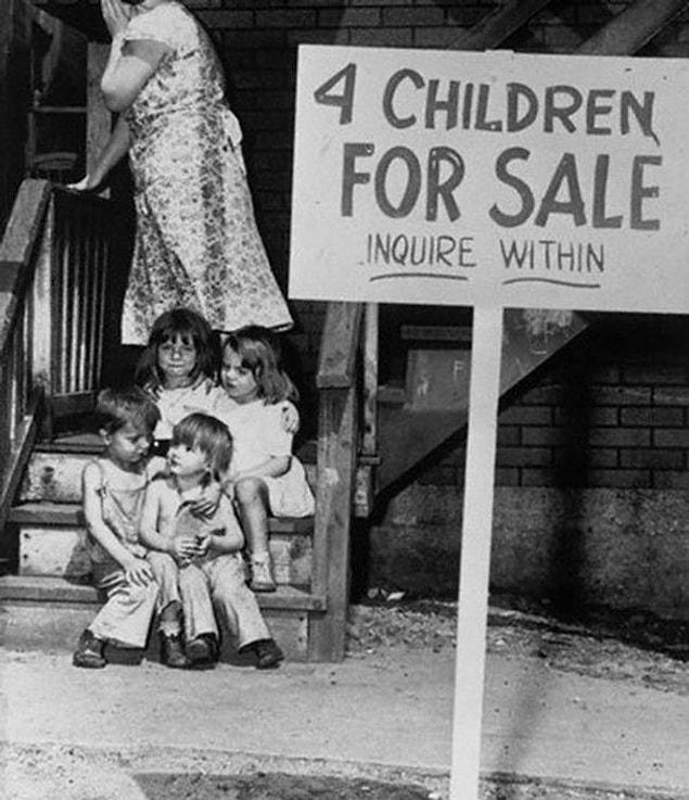 3. Mother Hides Her Face In Shame After Putting Her Children Up For Sale, Chicago, 1948