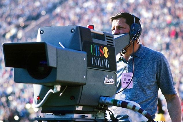 7. A cameraman for the CBS television network follows pregame warm-ups prior to Super Bowl I.