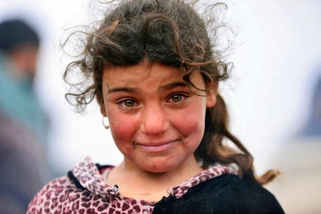 12. An Iraqi girl forced to flee her home cries during a battle between Iraqi forces and ISIS militants near Badush, Iraq, on March 16.