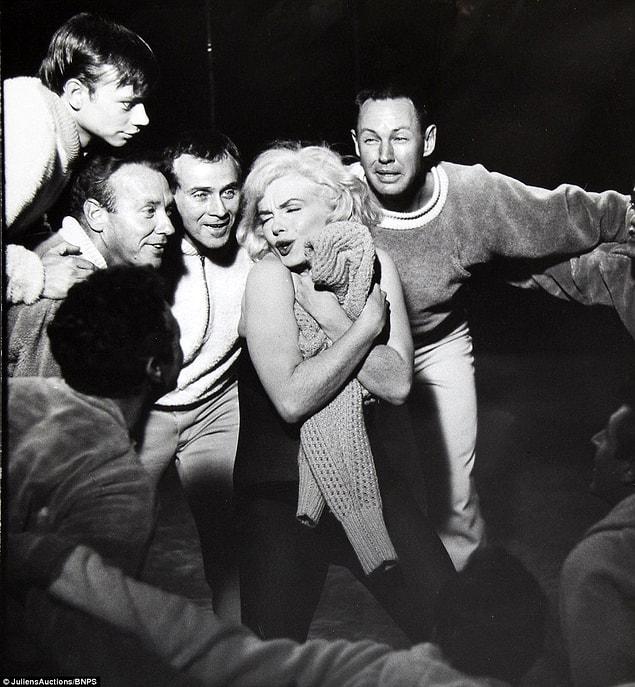 Monroe showed off her irrepressible charm with the cast on the set of Let's Make Love, shot by Nat Dallinger.