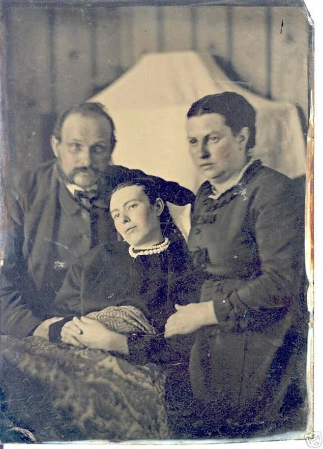 Parents posed with their dead daughter.