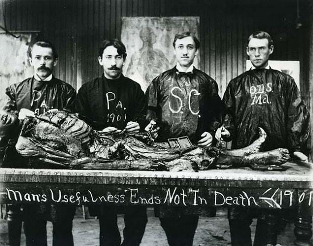 12. An anatomy class posing with a cadaver, 1901.