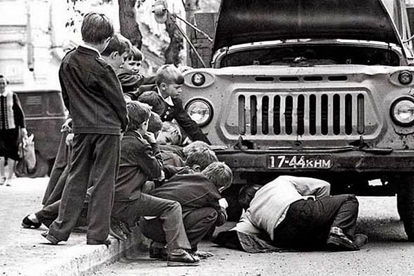 9. Чью-то поломанную машину собирались чинить всем двором, а любопытные мальчишки бегали вокруг да около и мешали взрослым :)