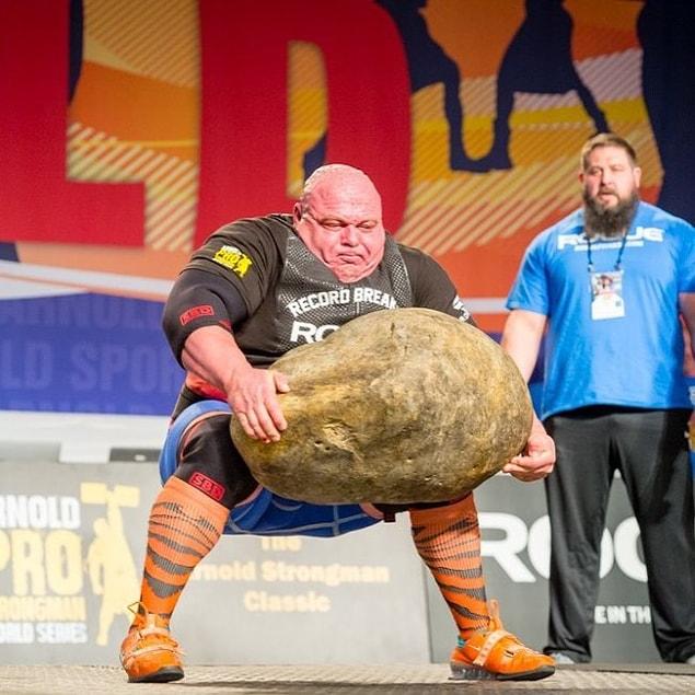 He is lifting the world’s largest potato off the ground, and then putting it back on the ground.