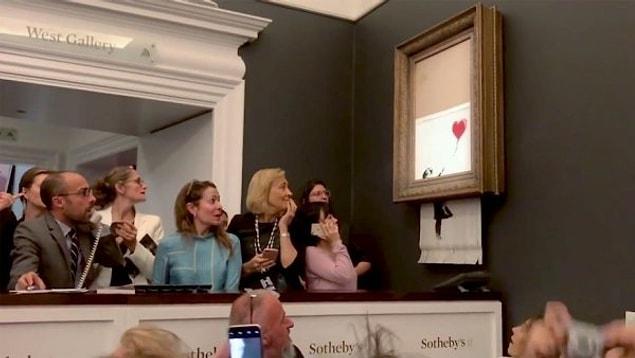 A Banksy painting “self-destructed” itself after being sold at an auction for $1.4 million.