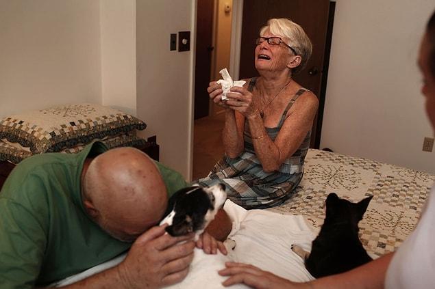 2. Marquita Leibe and his wife Donald crying next to their dog, Daisy, after being asleep.