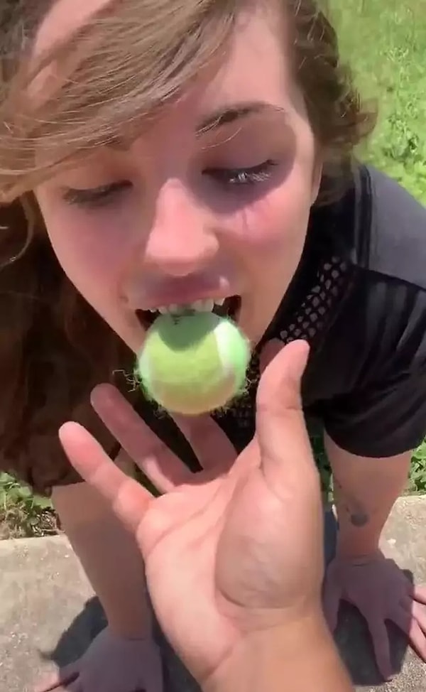 В этом образе девушка играет с мячом, кувыркается на траве и...ест собачью еду