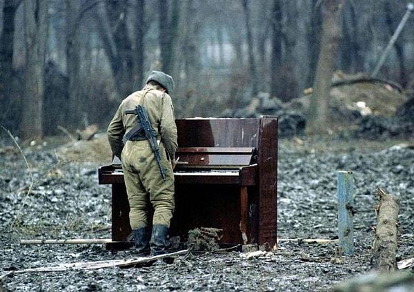 39. 1994 yılında Çeçenya'da terk edilmiş bir piyanoyu çalan Rus askeri.