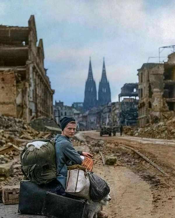 47. Köpeğiyle ve tüm eşyalarıyla Köln harabelerinde tek başına oturan Alman bir kadın, 1945.