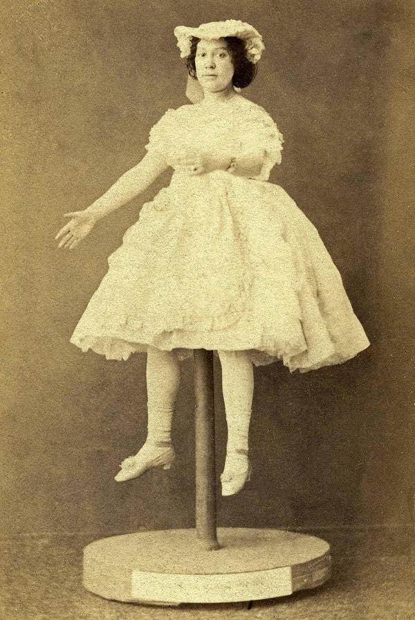 A woman deciding to pose as a toy doll for her photograph.