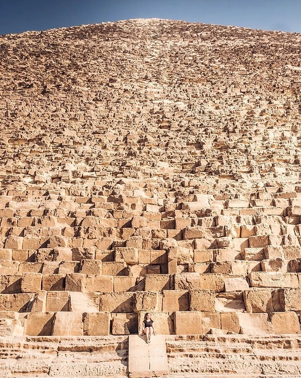 The actual size of the pyramids. If you look closely, you can spot a woman sitting in the foreground.