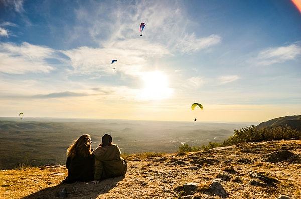 Türkiye's diverse geography offers paragliders a wide range of experiences, from soaring over coastal cliffs to gliding above ancient ruins and mountain peaks.