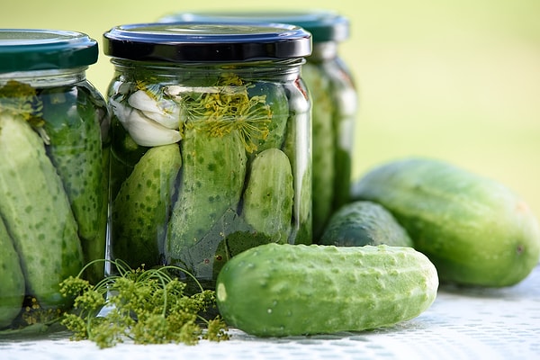 The orange glow comes from sodium, while the glowing tip is the wettest part of the pickle.